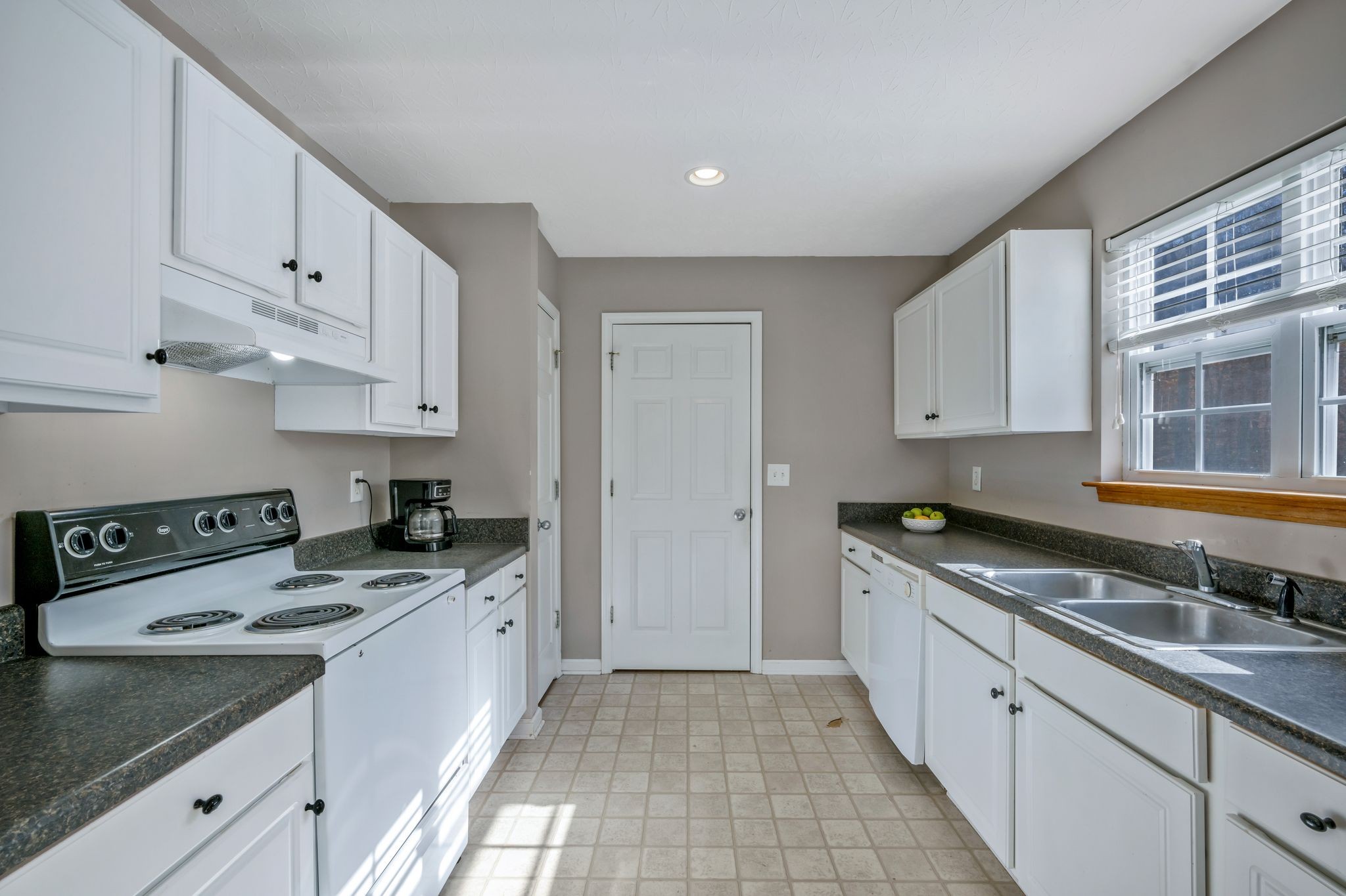 1427 St Paul Road Charlotte, TN 37036 - Photo 9 of 38 a kitchen with granite countertop a sink a stove and cabinets
