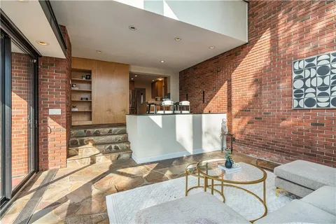 a living room with furniture and large windows