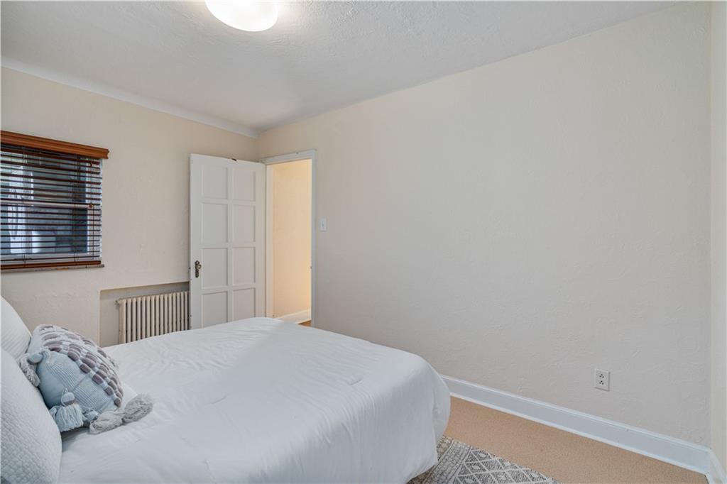 943 Wellesley Road Pittsburgh, PA 15206 - Photo 18 of 34 a bedroom with a bed and a window