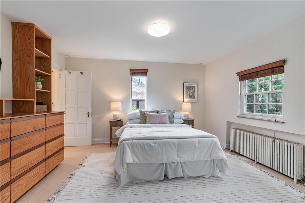 943 Wellesley Road Pittsburgh, PA 15206 - Photo 19 of 34 a bedroom with a bed and a window