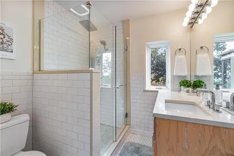 a bathroom with a sink a large mirror and a shower