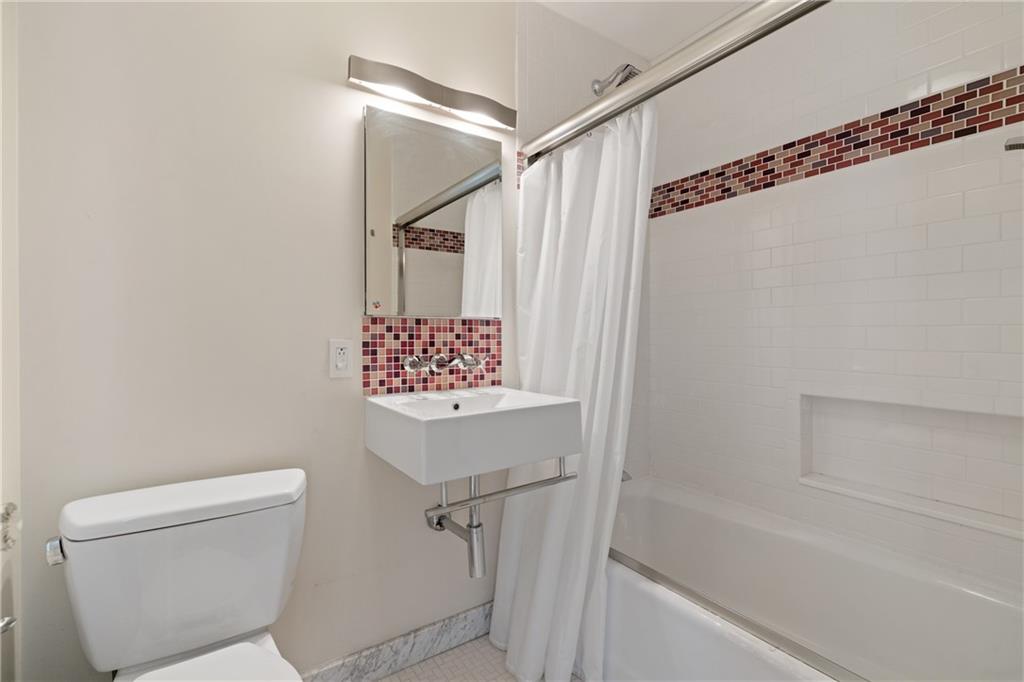 943 Wellesley Road Pittsburgh, PA 15206 - Photo 24 of 34 a bathroom with a shower and a toilet