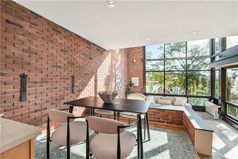 a dining room with furniture and window