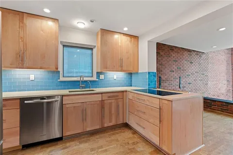 a kitchen with a sink cabinets and wooden floor