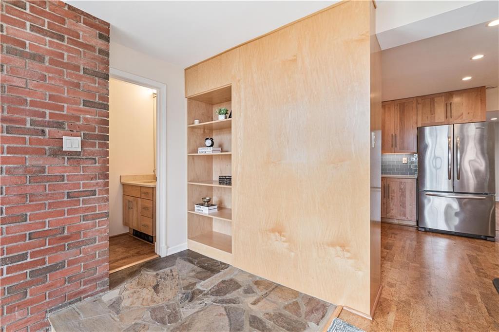943 Wellesley Road Pittsburgh, PA 15206 - Photo 10 of 34 a view of a refrigerator in kitchen and wooden floor