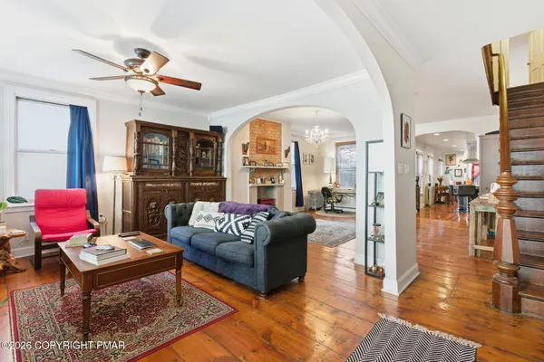 a living room with furniture a rug and a chandelier