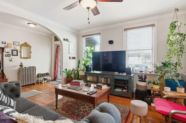 a living room with furniture and a flat screen tv