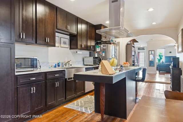 a kitchen with granite countertop a sink cabinets and stainless steel appliances