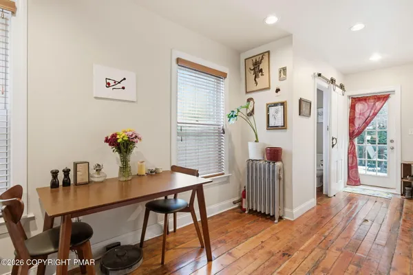 a view of a workspace with furniture and wooden floor