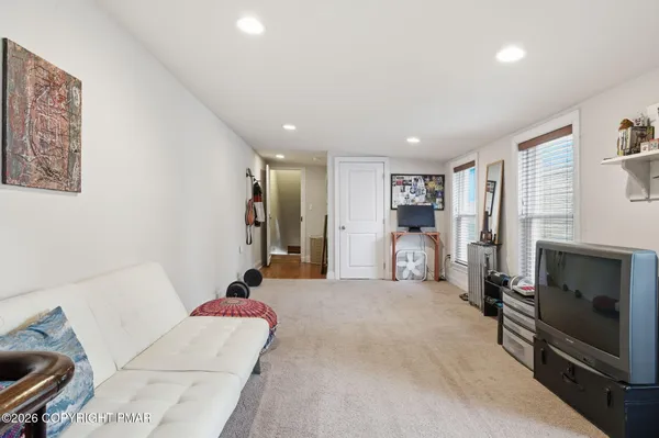 a living room with furniture gym equipment and a fireplace