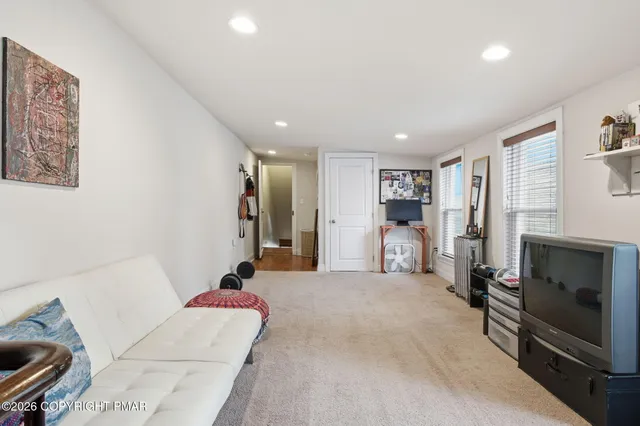 a living room with furniture gym equipment and a fireplace