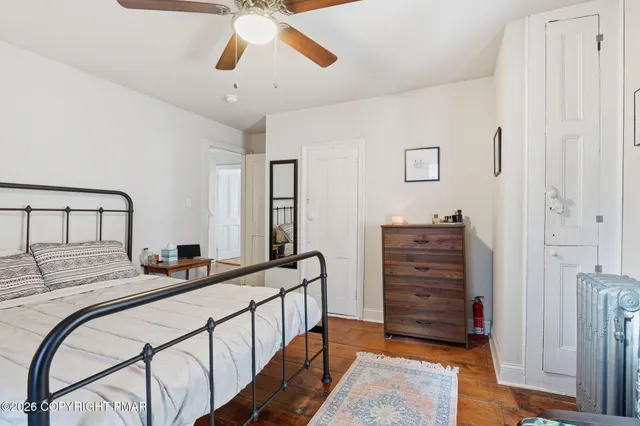 a bedroom with bed and cabinets