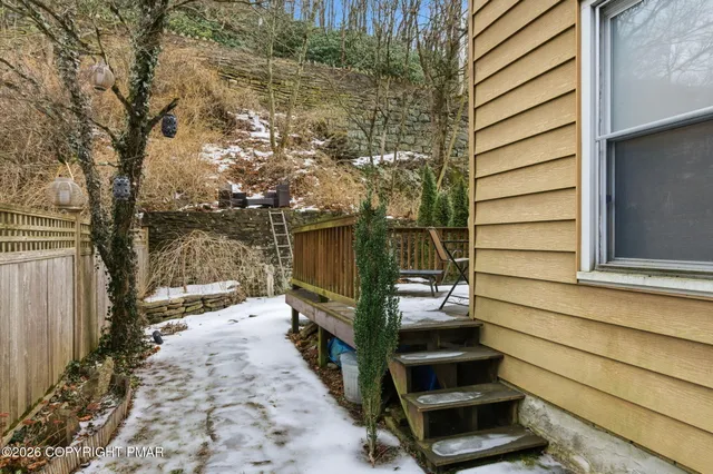 a view of roof deck with furniture and trees