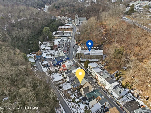 an aerial view of a house with a swimming pool