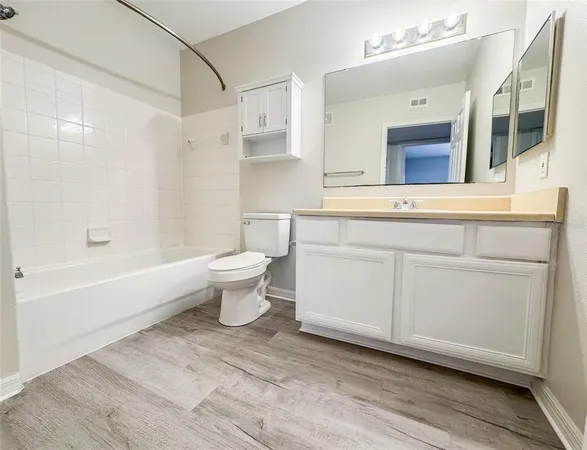 a bathroom with a sink a toilet and bathtub