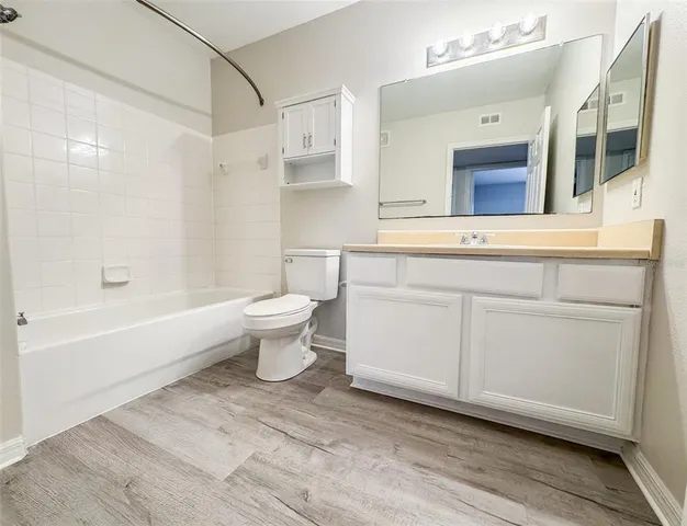 a bathroom with a sink a toilet and bathtub