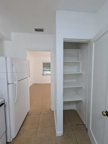 a view of a closet area with living room