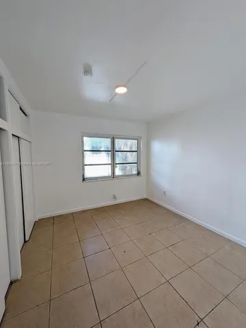 a view of an empty room and a window