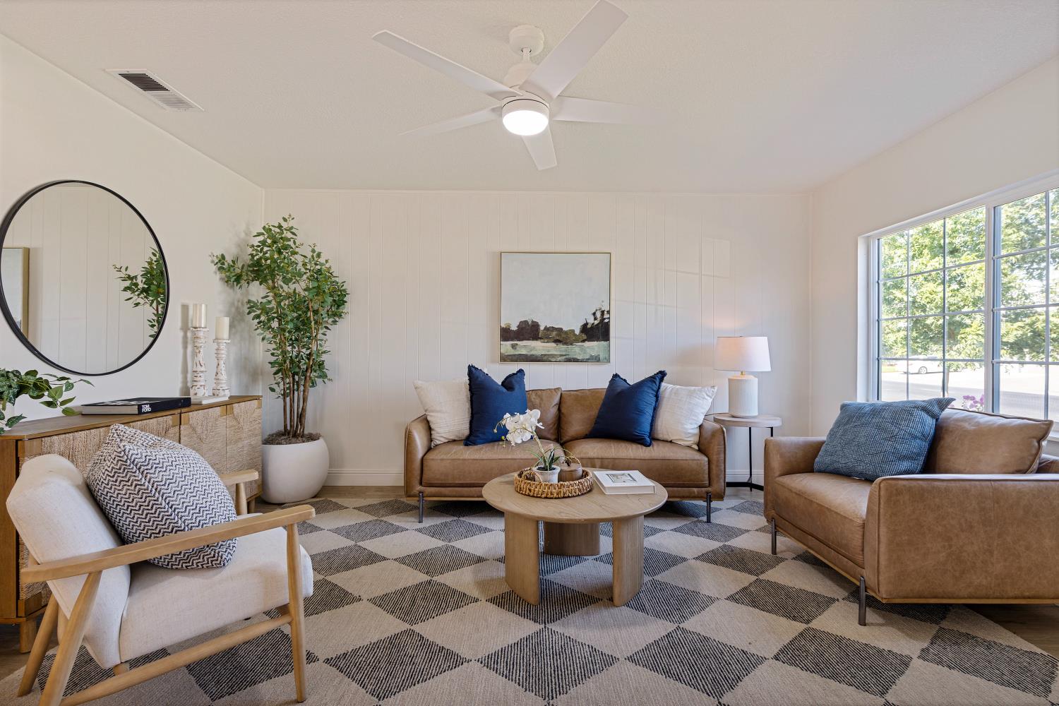 a living room with furniture a rug a lamp and a window