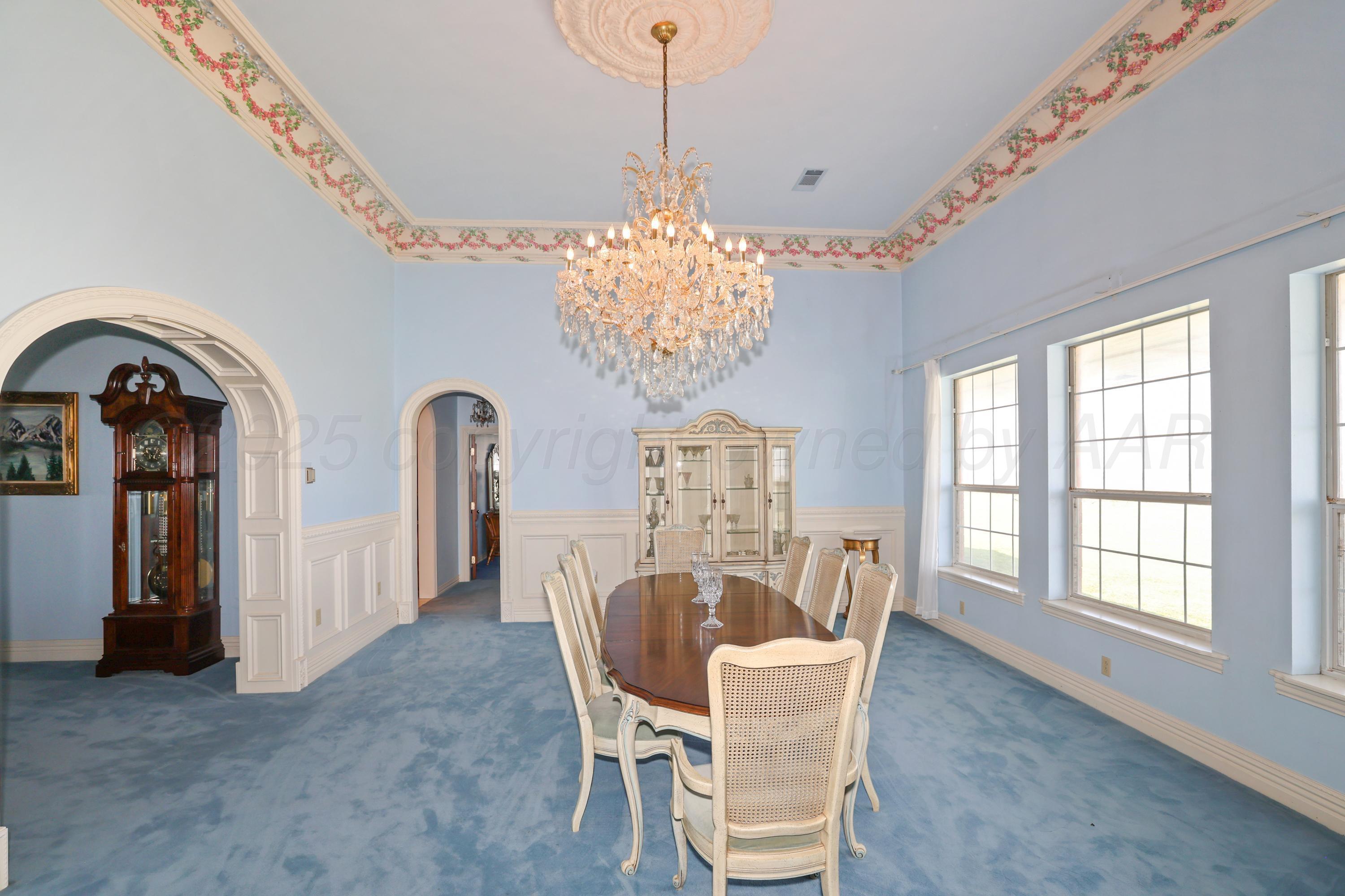 1401 County Road K Panhandle, TX 79068 - Photo 11 of 53 a dining room with furniture a chandelier and window