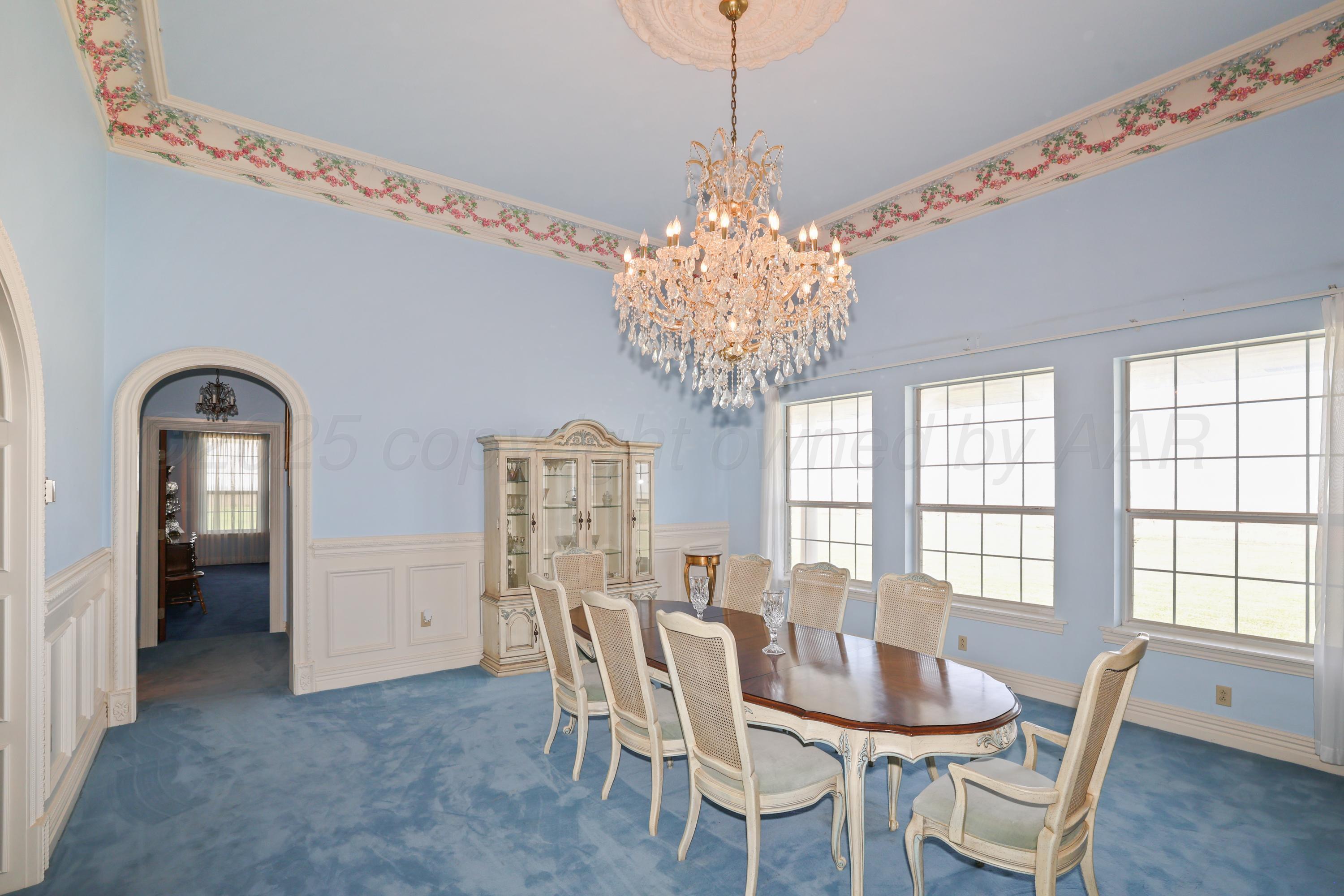 1401 County Road K Panhandle, TX 79068 - Photo 12 of 53 a view of a dining room with furniture and chandelier