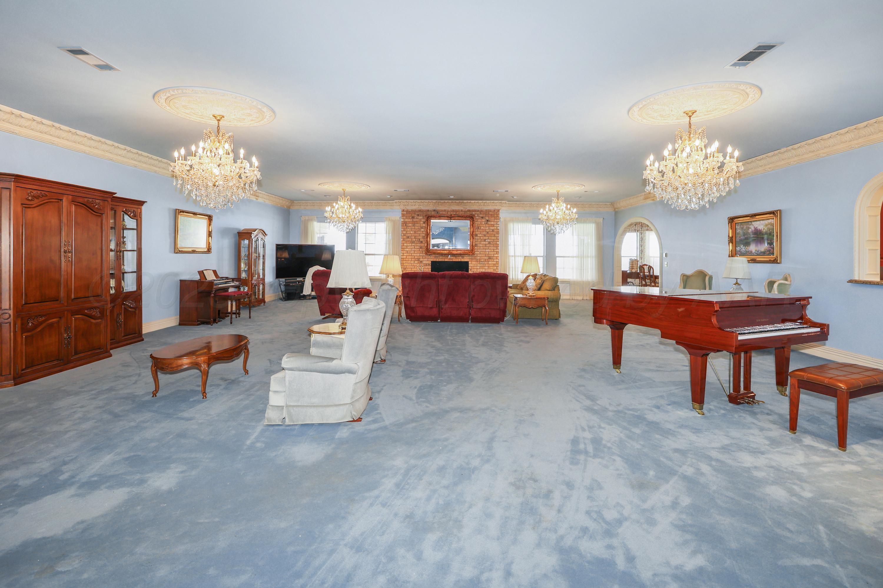 1401 County Road K Panhandle, TX 79068 - Photo 14 of 53 a living room with furniture and a chandelier