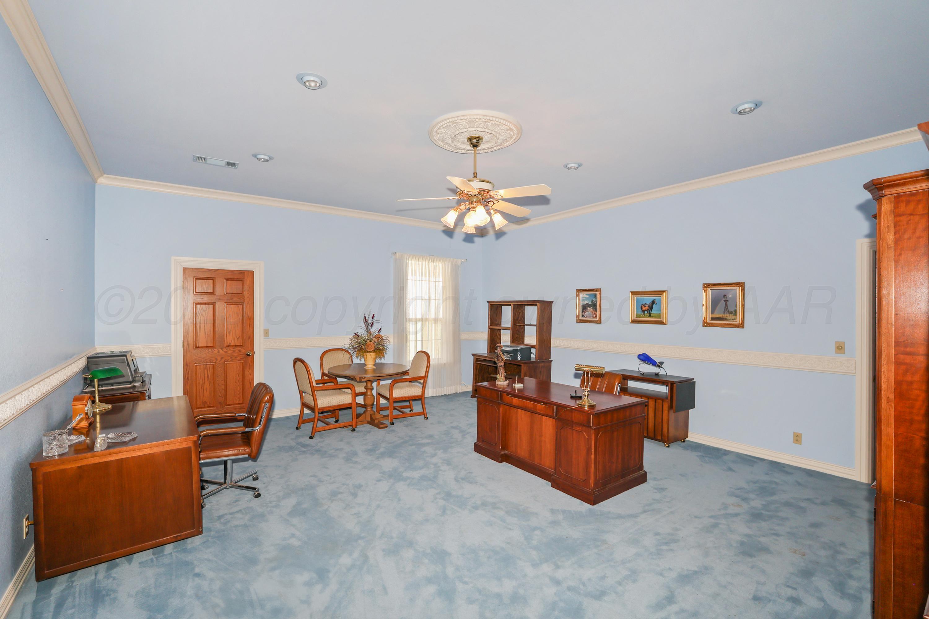 1401 County Road K Panhandle, TX 79068 - Photo 20 of 53 a living room with furniture and a chandelier