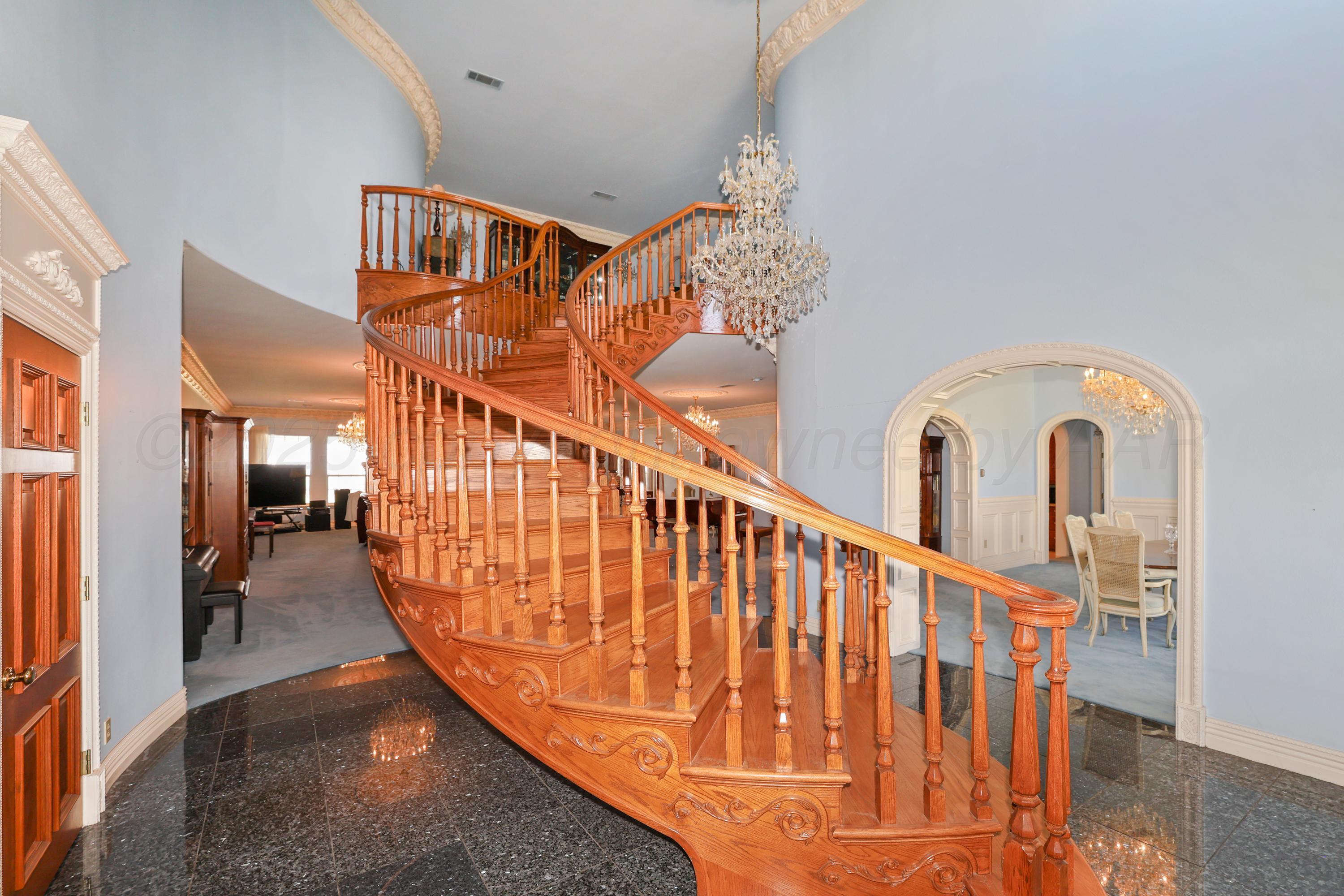 1401 County Road K Panhandle, TX 79068 - Photo 2 of 53 a view of staircase with railing and a chandelier
