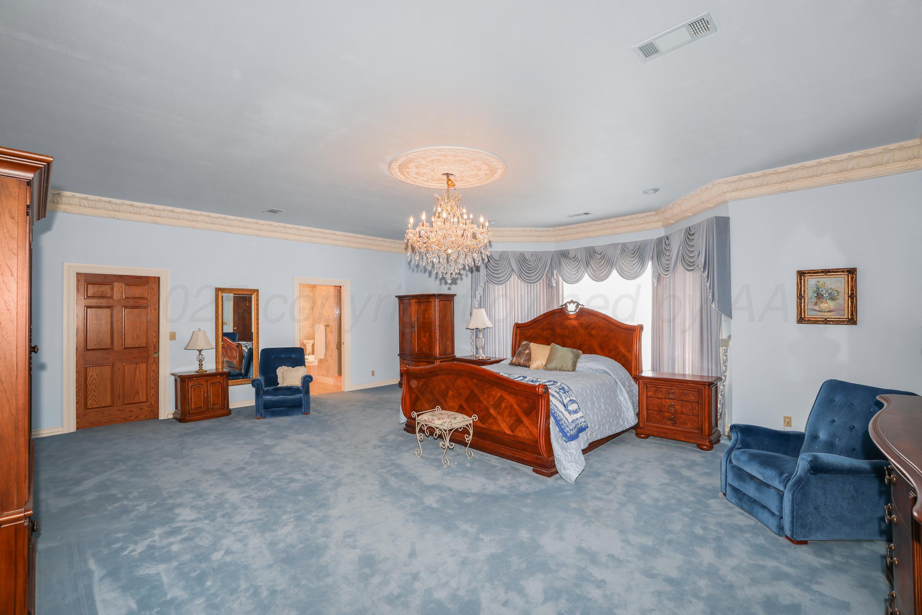 1401 County Road K Panhandle, TX 79068 - Photo 21 of 53 a spacious bedroom with a bed and a couch