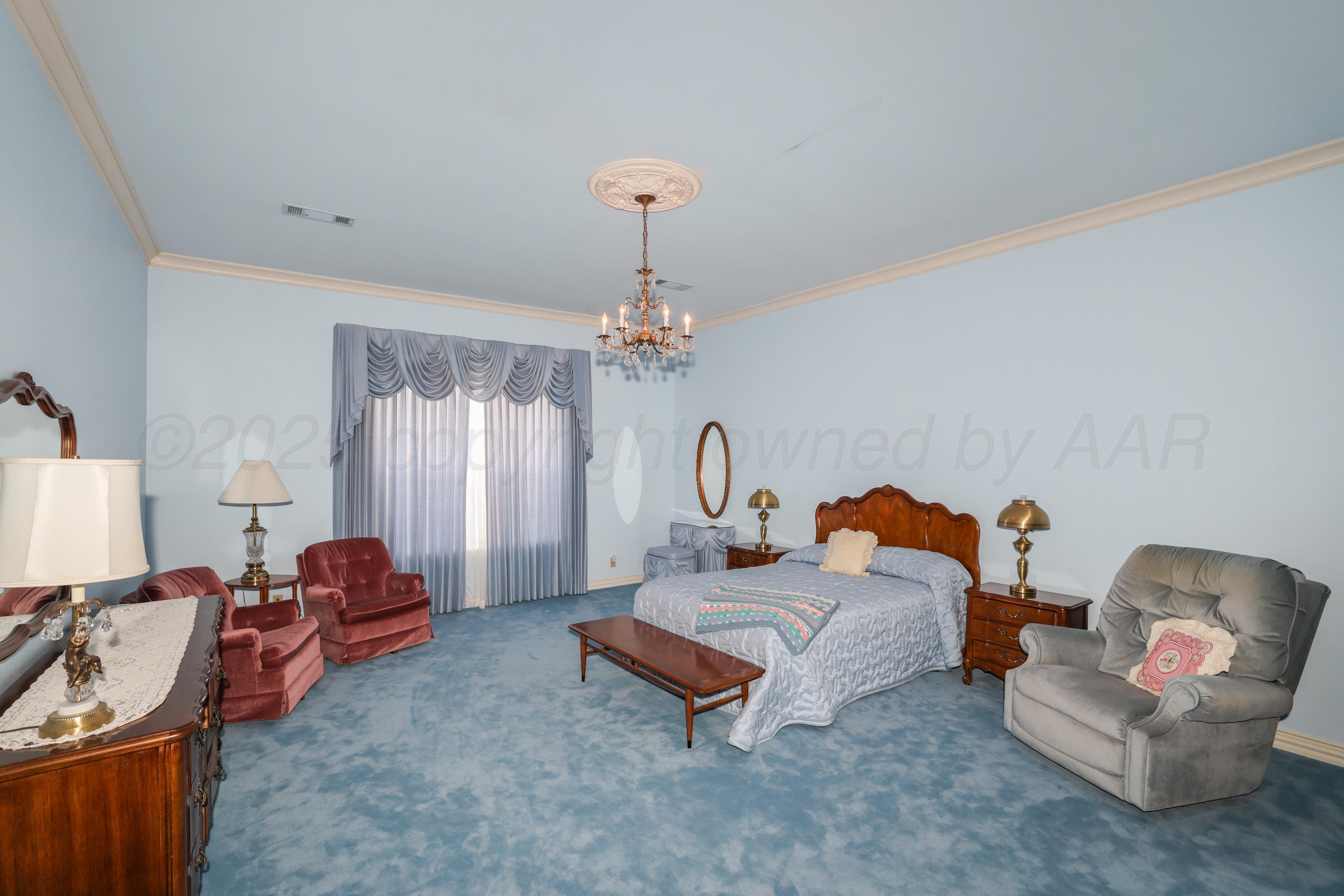 1401 County Road K Panhandle, TX 79068 - Photo 26 of 53 a living room with furniture a rug and a chandelier