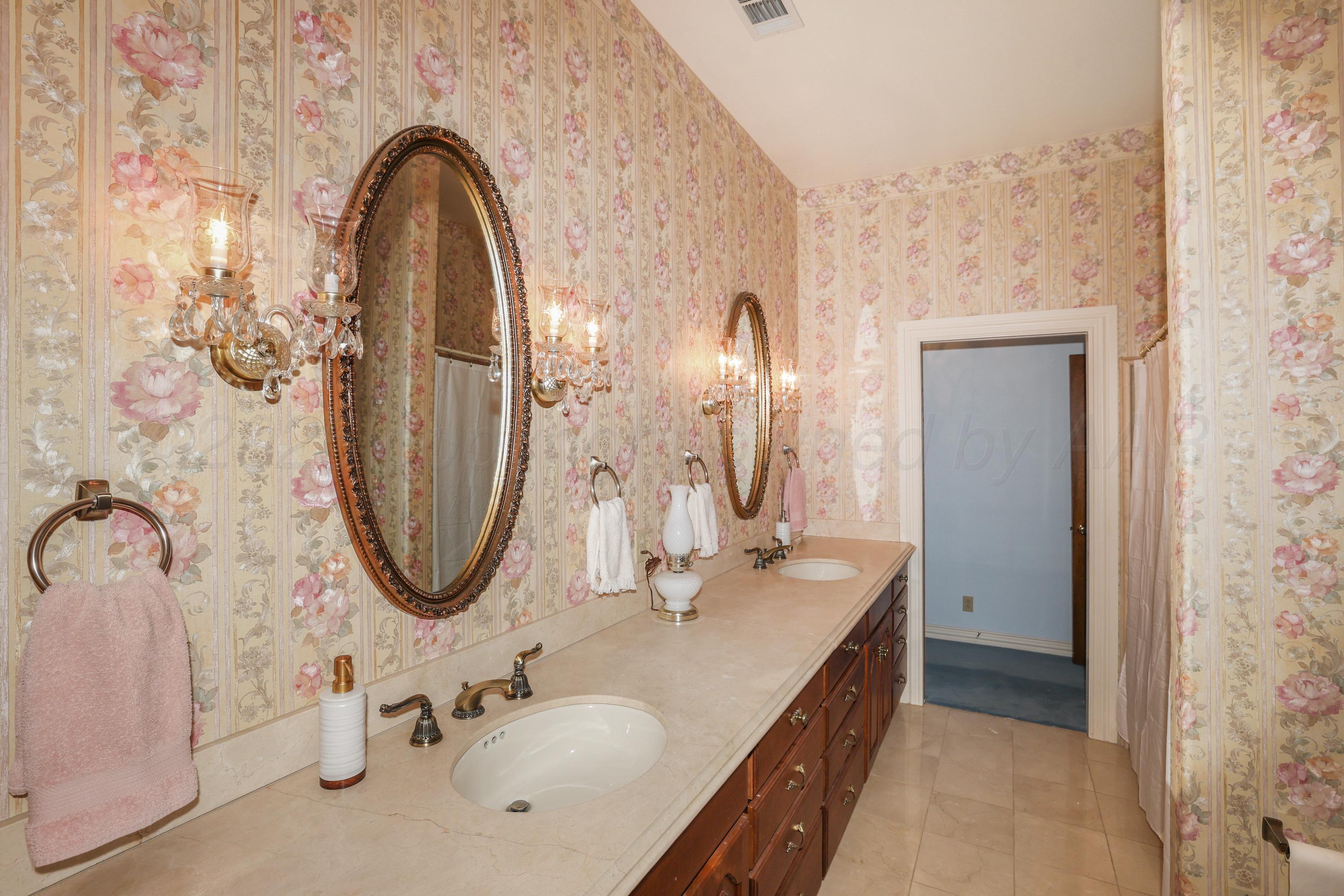 1401 County Road K Panhandle, TX 79068 - Photo 27 of 53 a bathroom with a sink and a mirror