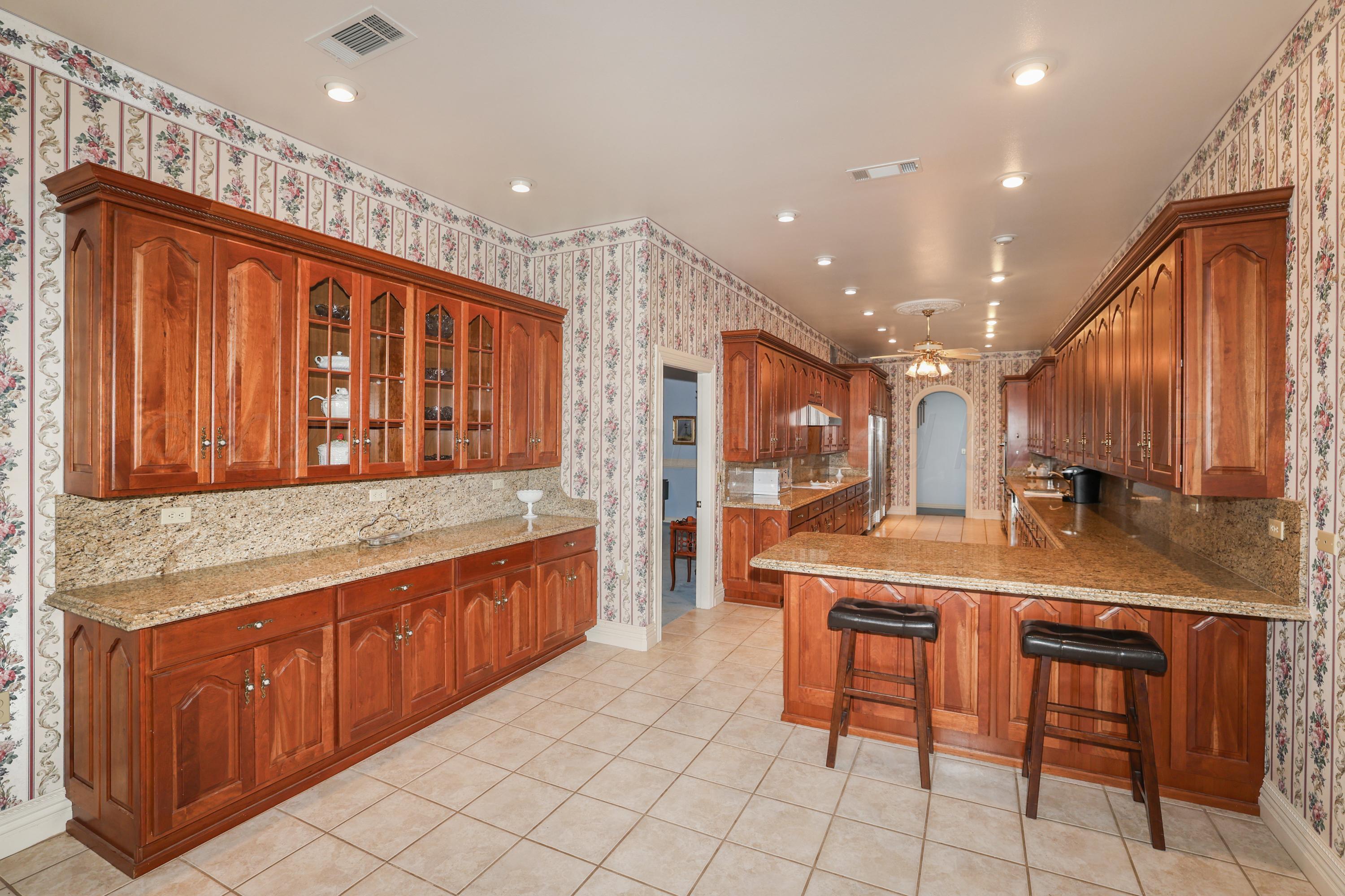 1401 County Road K Panhandle, TX 79068 - Photo 4 of 53 a kitchen with stainless steel appliances granite countertop a sink and cabinets