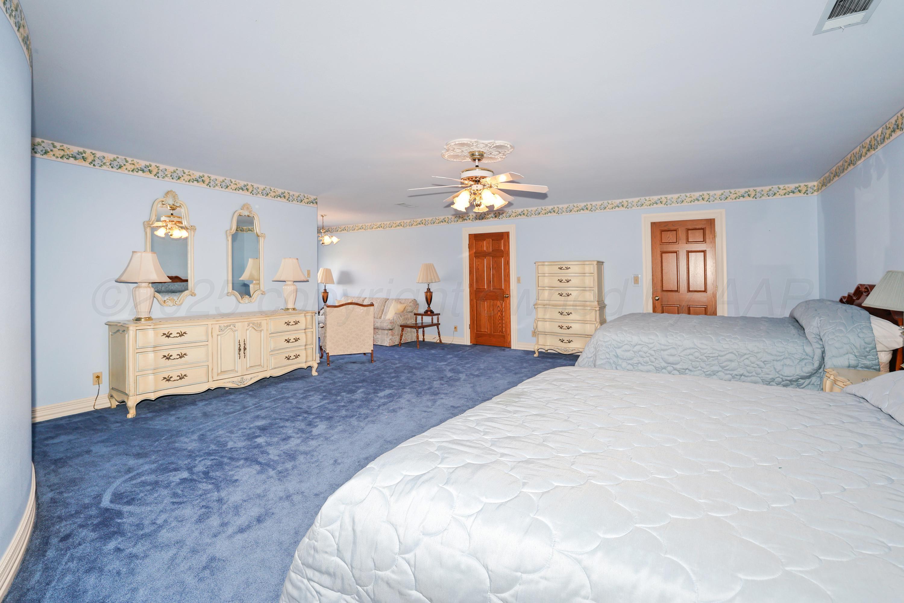 1401 County Road K Panhandle, TX 79068 - Photo 44 of 53 a spacious bedroom with a bed and a cabinets