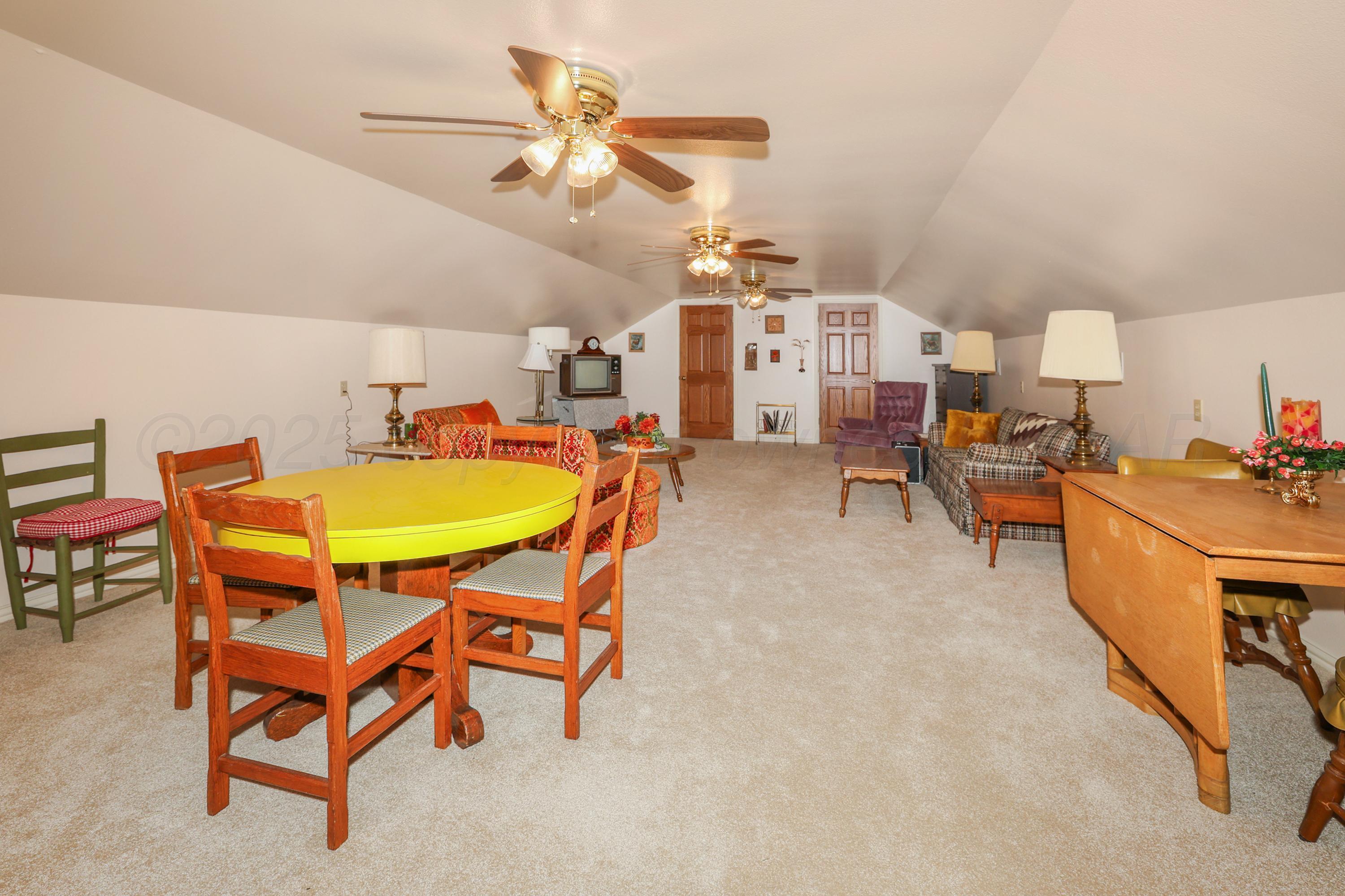 1401 County Road K Panhandle, TX 79068 - Photo 48 of 53 a living room with furniture a flat screen tv and kitchen view