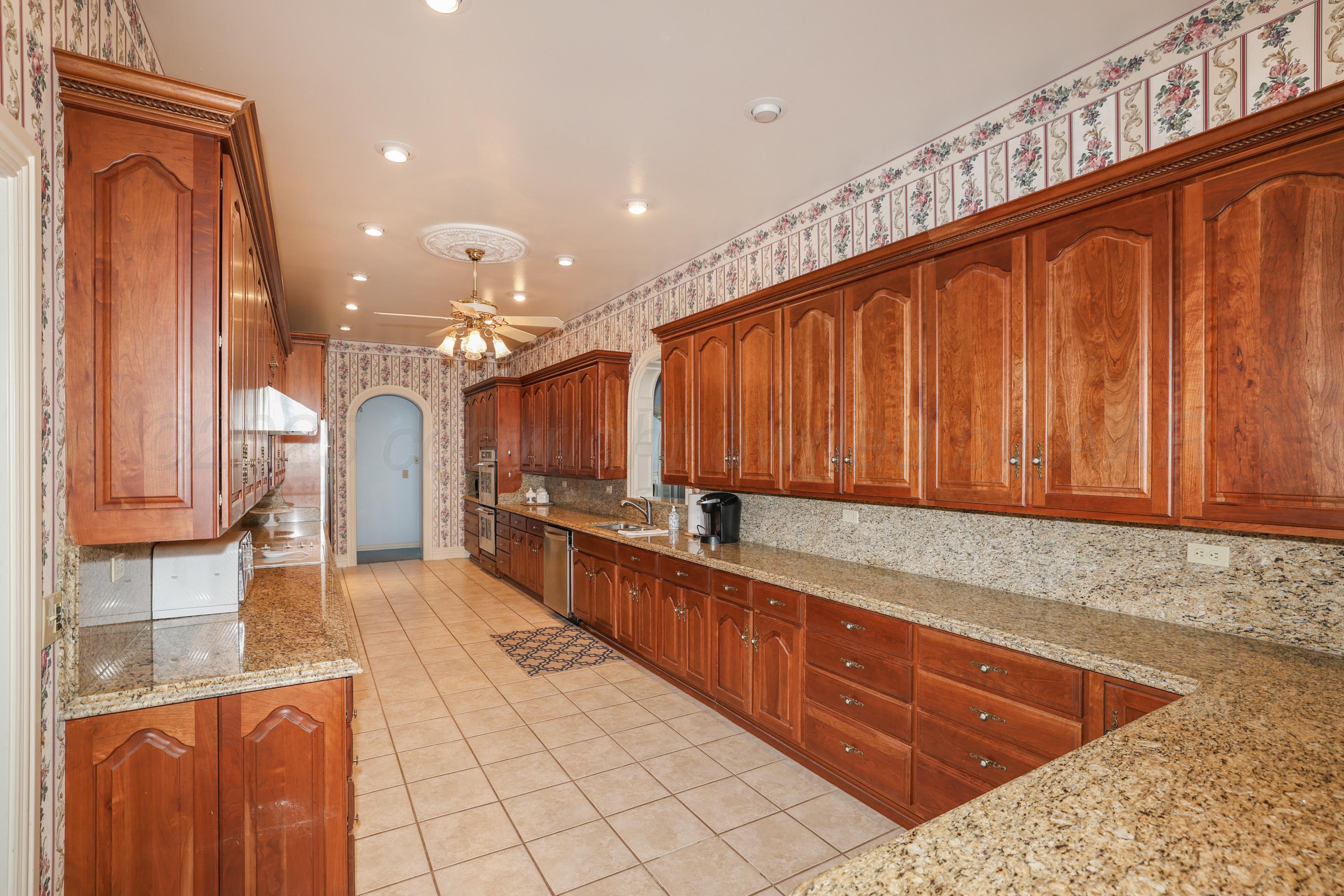 1401 County Road K Panhandle, TX 79068 - Photo 5 of 53 a large kitchen with stainless steel appliances granite countertop a sink and cabinets