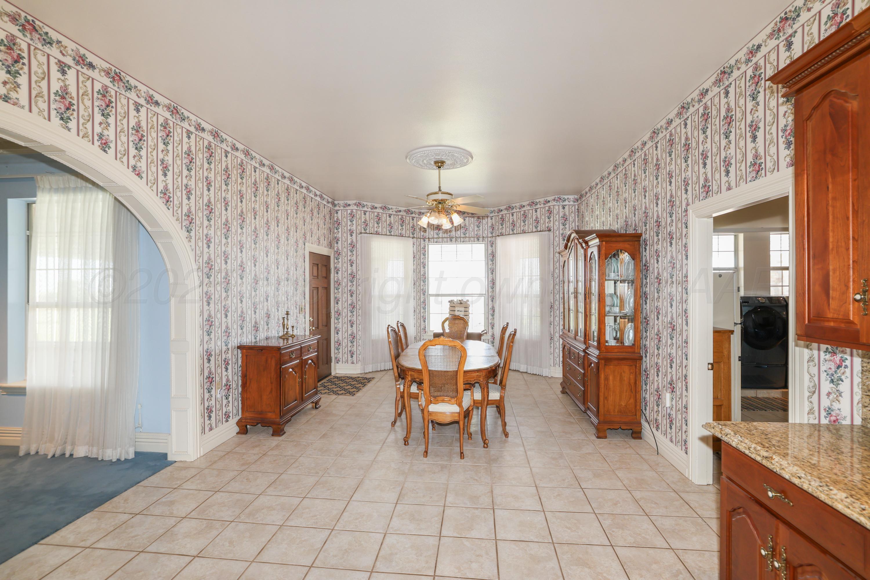 1401 County Road K Panhandle, TX 79068 - Photo 9 of 53 a view of a dining room with furniture and chandelier
