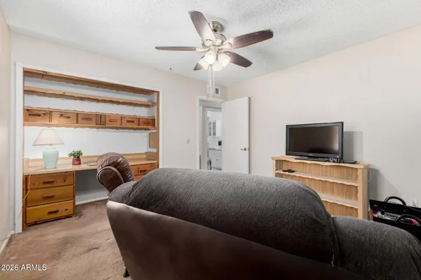 a bedroom with a bed and a television