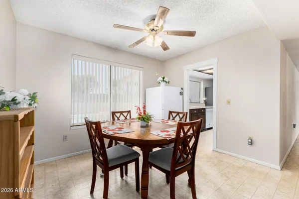 a view of a dining room with furniture and window