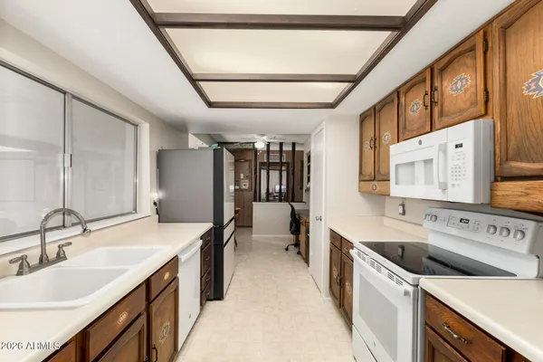 a kitchen with a sink stove and cabinets