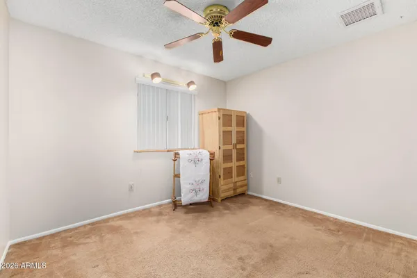 an empty room with closet and windows