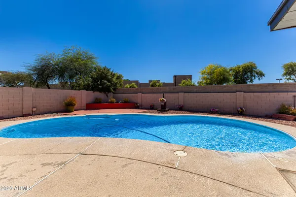 a view of a swimming pool with an outdoor space and seating area