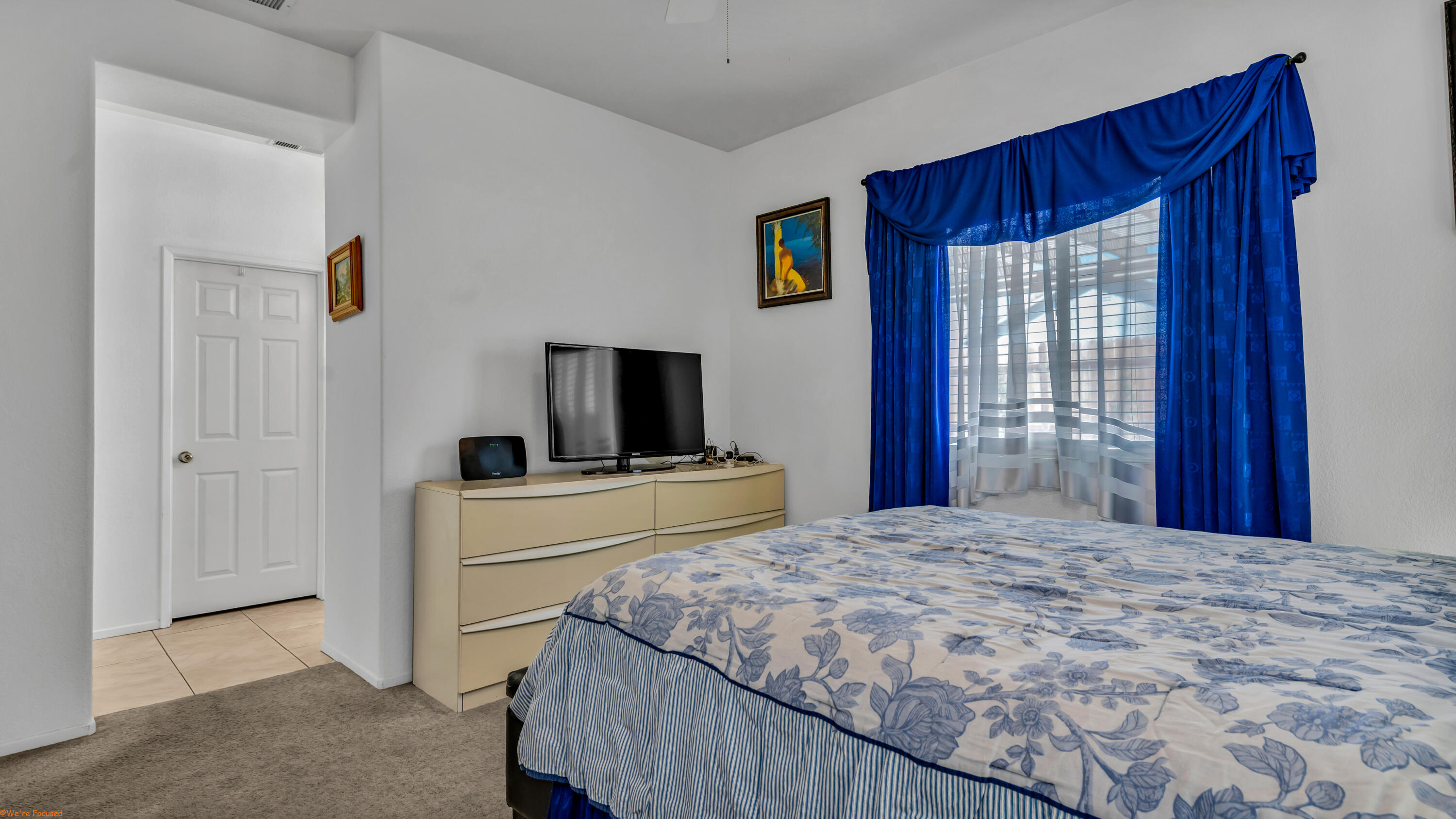 83644 Jaderock Road Coachella, CA 92236 - Photo 15 of 42 a bedroom with a large bed and a flat tv screen