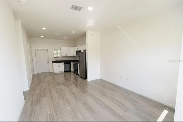 a view of a kitchen with a sink and microwave