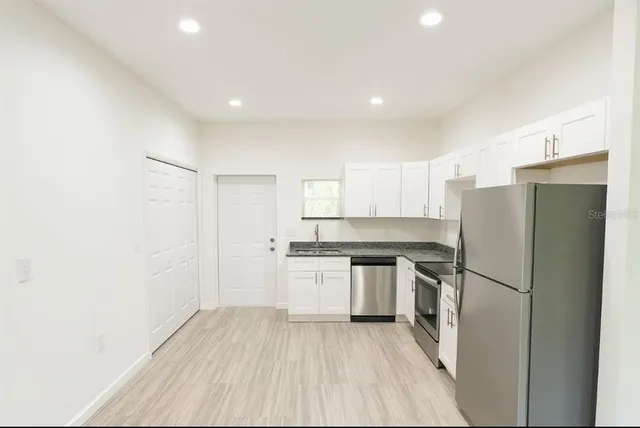 a kitchen with a refrigerator a sink and dishwasher