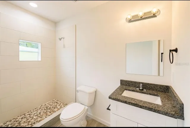 a bathroom with a sink toilet and shower