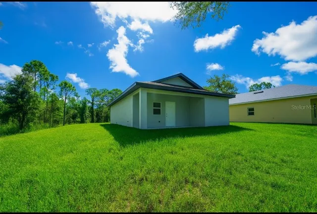 a view of a backyard of the house