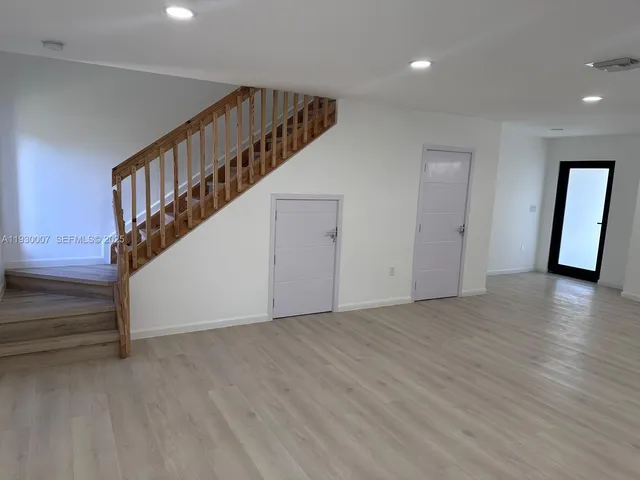 a view of an entryway with wooden floor