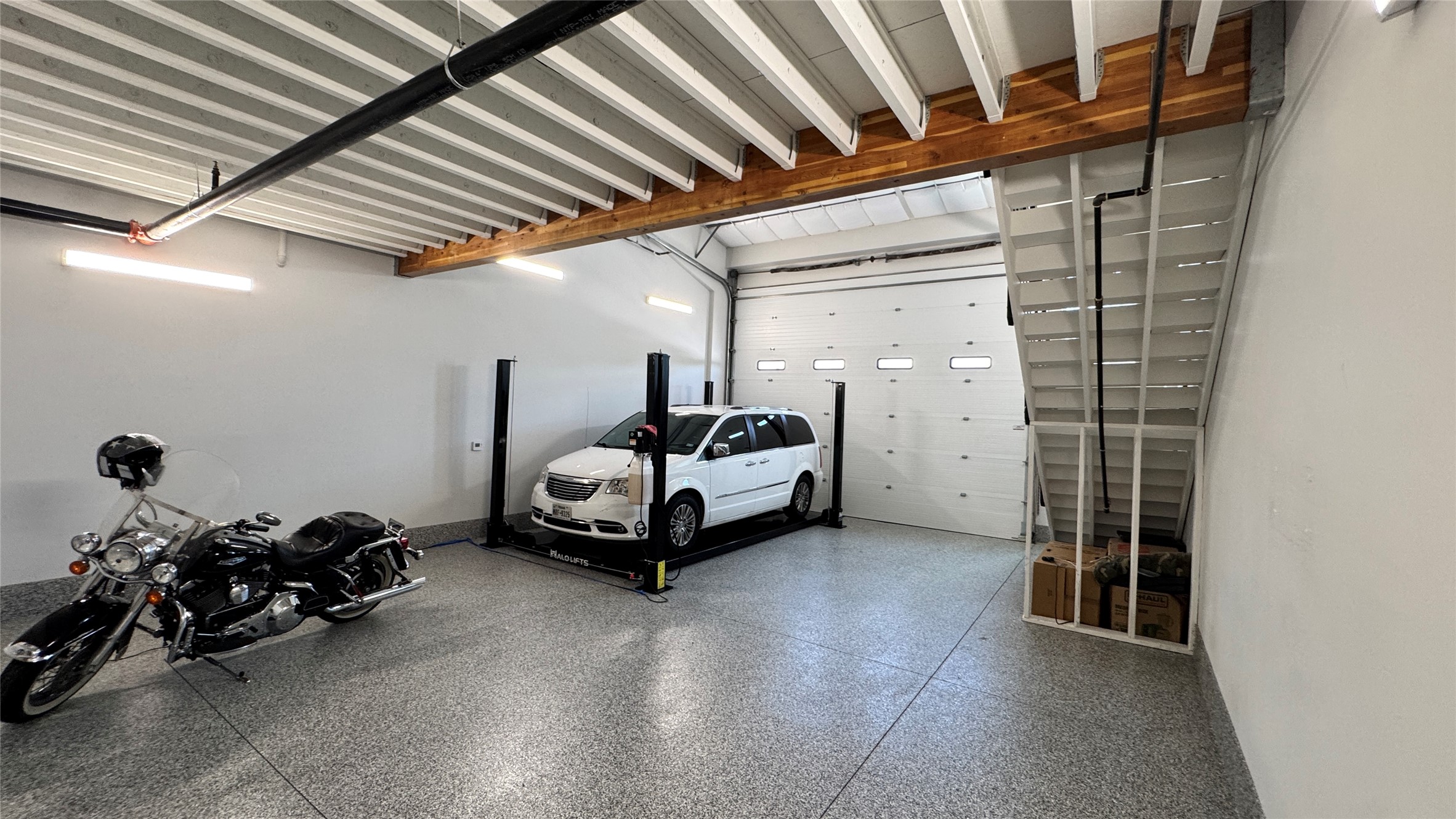 1009 Ranch Road 620 North, Unit 401 Lakeway, TX 78734 - Photo 6 of 15 Functional garage offering ample storage and an integrated car lift.