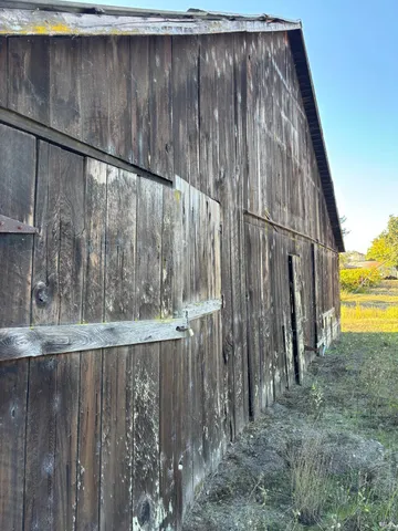 a black and white building with trees in the background