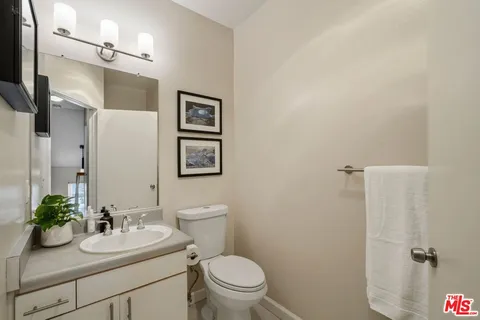 a bathroom with a sink toilet and a mirror
